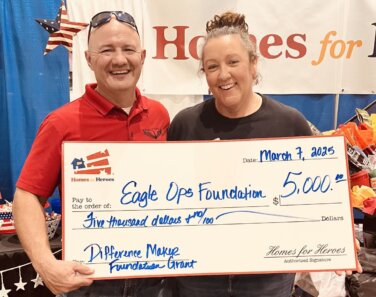 Jonathan Sheperd Emily Machetta hold 5000 big check grant for Eagle OPS Foundation at event from Homes for Heroes Foundation