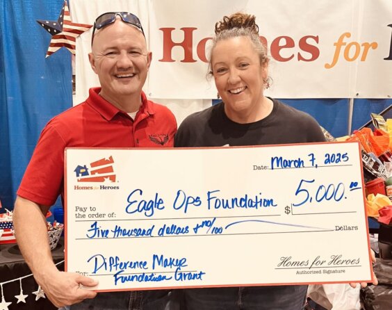 Jonathan Sheperd Emily Machetta hold 5000 big check grant for Eagle OPS Foundation at event from Homes for Heroes Foundation